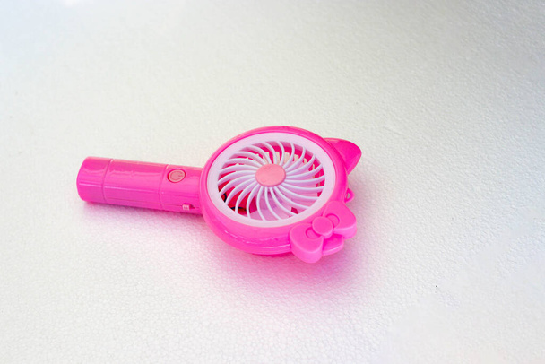 Close-up view of pink handy mini fan isolated on white background - Foto, Bild