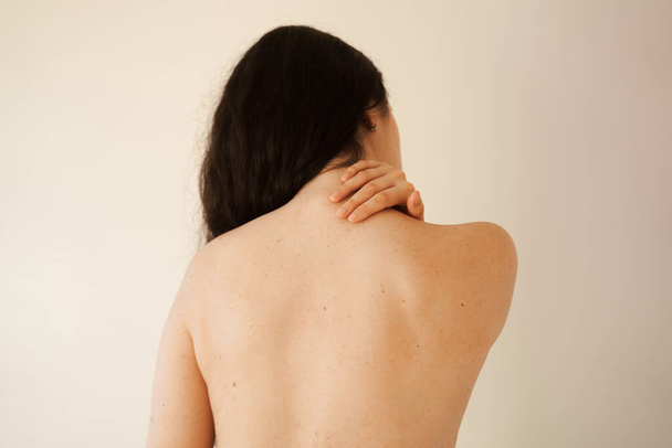 Cervical spine osteochondrosis is radicular syndromes of young woman. Attractive girl feel spine pain because of spinal nerves compression - 写真・画像