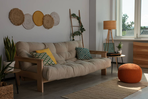 Beautiful living room interior with stylish beige sofa - Фото, изображение
