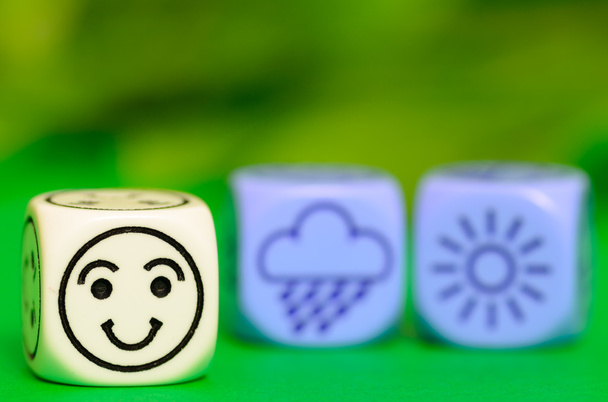 concept of summer weather - emoticon and weather dice on green b - Photo, Image