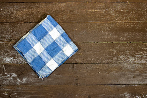 blue and white checkered napkin isolated on wood table - Photo, Image