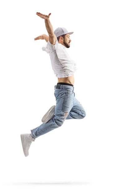 Full length profile shot of a male dancer in a jumping pose isolated on white background - Fotografie, Obrázek