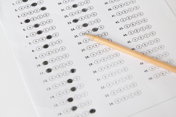 Standardized test form with answers bubbled in and a pencil, foc - Photo, Image
