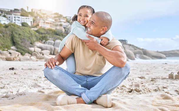 Shot of adorable little cheerful girl hugging her father from behind while bonding together at the beach. Carefree dad having fun with playful daughter during summer seaside vacation on the shore. - Photo, Image