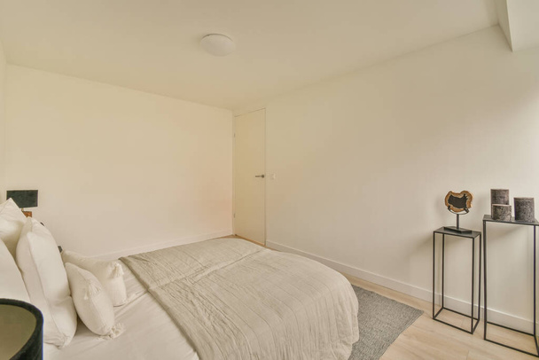 Diseño interior de la casa de dormitorio con cama y armario de madera situado en esquina cerca de la ventana en apartamento moderno - Foto, imagen
