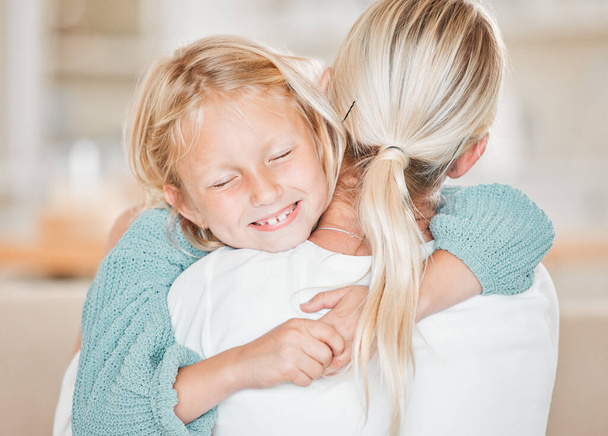 Cropped shot of an adorable little girl embracing her mom lovingly at home. - Photo, image