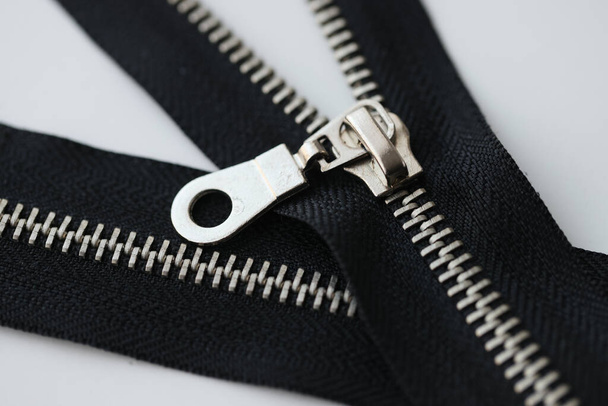 Top view of open and closed metal zippers for clothing on white background. Zip fastener or zip for sewing and clothes design - Foto, Imagem
