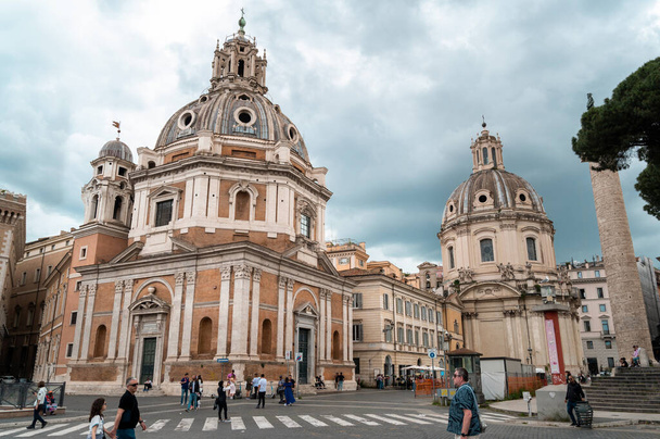 ROME, ITALY - JUNE, 2022: Street scape of the ancient centre of the city. Santa Maria di Loreto and Trajan Column, walking people, old buildings around - Photo, Image