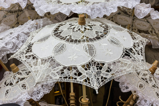 white umbrellas. Sun protection, hot weather concept. Traditional souvenirs in Burano island, Venice, Italy - Fotoğraf, Görsel