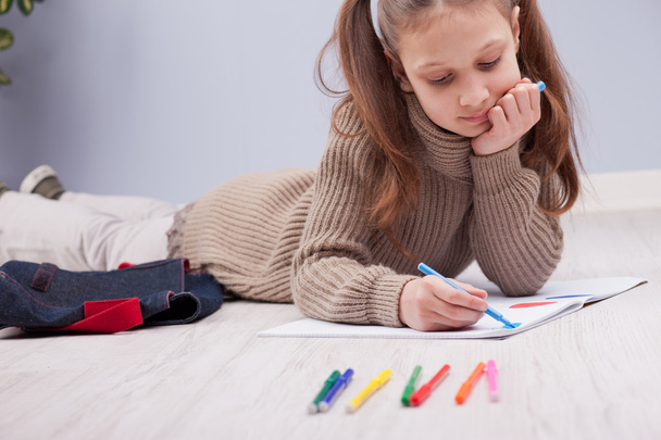 little girl colouring on her notebook - Photo, Image