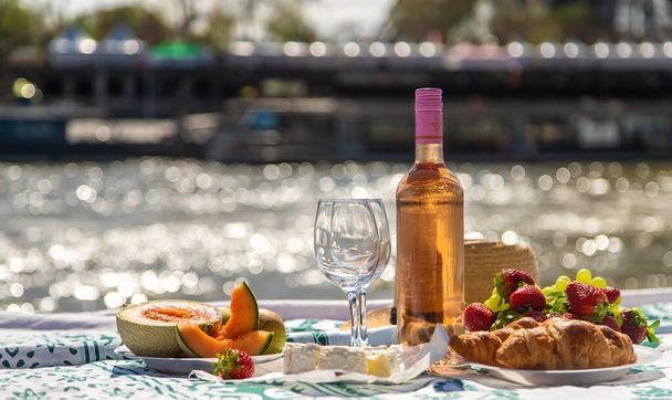 Picnic and wine near the Eiffel Tower. Selective focus. Food. - Photo, Image