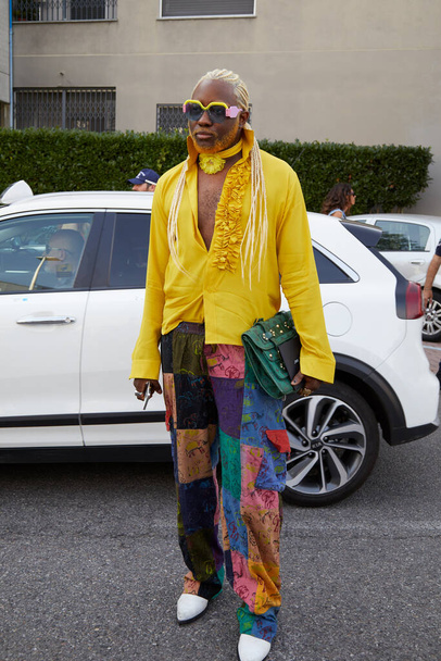 MILAN, ITALY - JUNE 17, 2022: Man with yellow shirt and blond braids before Dsquared2 fashion show, Milan Fashion Week street style - Photo, Image