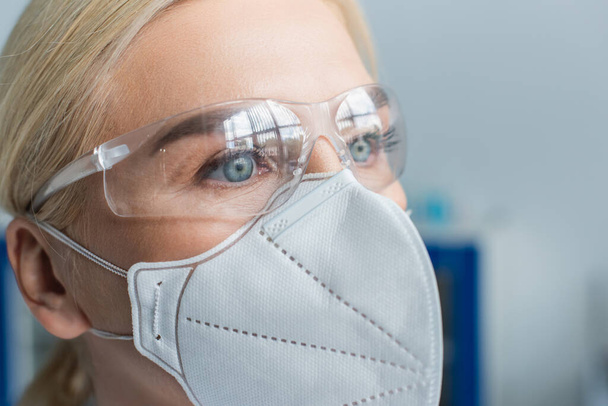 Portrait of scientist in protective mask and goggles in laboratory - Φωτογραφία, εικόνα
