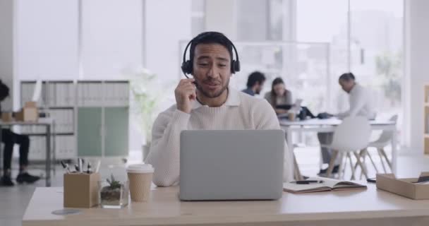 Portrait of a male call center agent talking to a customer on a call online. Salesperson having conversations with people on the web. Digital advisor consulting with a client on the internet. - Filmati, video