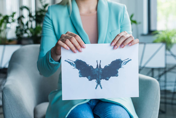 Cropped view of psychologist holding Rorschach test in consultation room  - 写真・画像