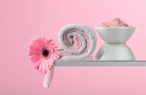 Spa composition with pink salt, Gerber, and towels on a pink background. Copy space. - Photo, Image
