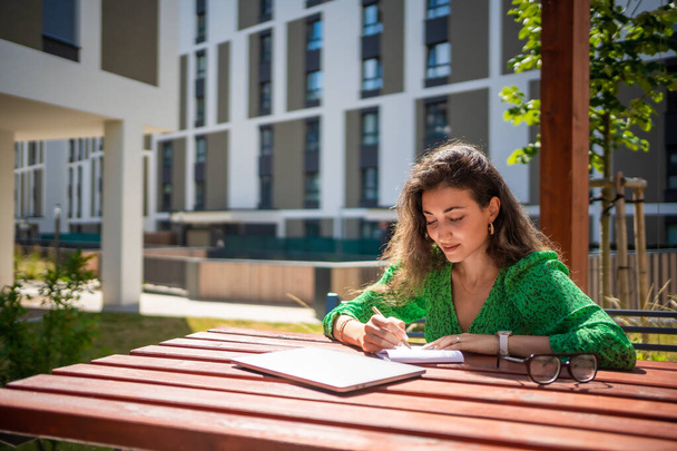 Caucasian woman drawing ideas on a notebook outside office. High quality photo - 写真・画像