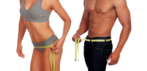 Corpi di uomo e donna che misurano la vita con metro a nastro
 - Foto, immagini