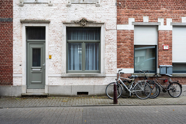 Leuven, Flemish Brabant Region, Belgium - 07 01 2022 - Facade of historical brick stone houses with bikes - Zdjęcie, obraz