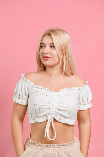 young beautiful girl in light clothes with white hair on a pink background - Valokuva, kuva