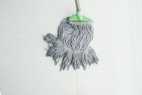 cleaning tiles floor with mop . - Photo, Image