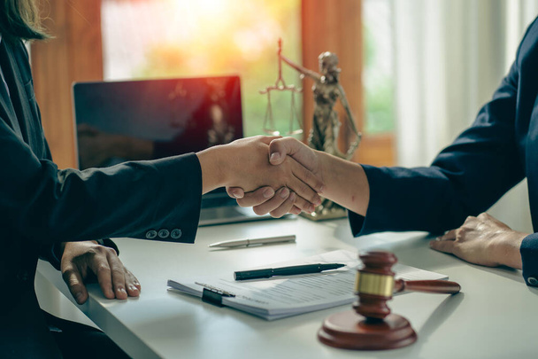 business people shake hands to make an agreement male judge legal advisor A court litigation planning service contract after co-operation and consultation between a male lawyer and a business client. - Fotó, kép