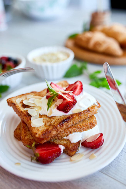 Breakfast of french toast with strawberries and maple syrup, good morning - Photo, Image