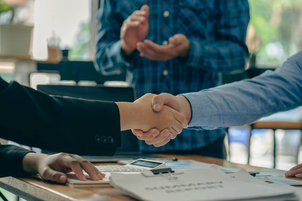 Close-up of business people shaking hands. End of meeting. Business etiquette. congratulations merger concept A businessman accepts or confirms a project as an offer and shakes hands at the office. - Photo, image
