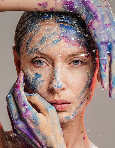 Beauty art portrait of woman with interesting abstract makeup. Bright, fashionable colors Colorful face paint. - Fotó, kép
