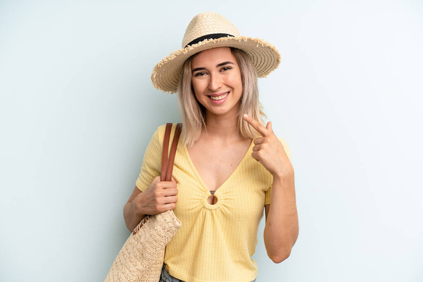 blonde woman smiling confidently pointing to own broad smile. summer concept - Fotografie, Obrázek