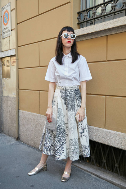 MILAN, ITALY - JUNE 20, 2022: Woman with white shirt and silver Dior shoes before Giorgio Armani fashion show, Milan Fashion Week street style - Valokuva, kuva