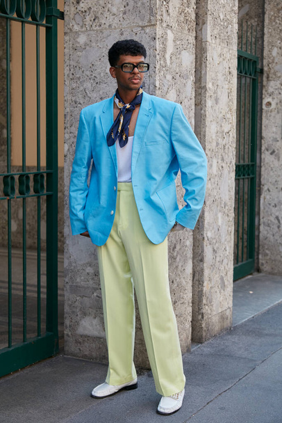 MILAN, ITALY - JUNE 20, 2022: Man with light blue jacket and pale green trousers before Giorgio Armani fashion show, Milan Fashion Week street style - Photo, Image