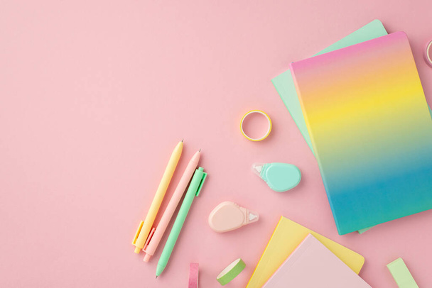 School accessories concept. Top view photo of colorful stationery rainbow color diary pens round correction tape ruler and adhesive tape on isolated pink background - Photo, image