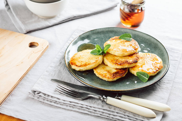 Cottage cheese pancakes with honey for breakfast. - Photo, image