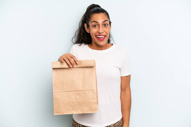 hispanic woman looking happy and pleasantly surprised. take away concept - Fotografie, Obrázek