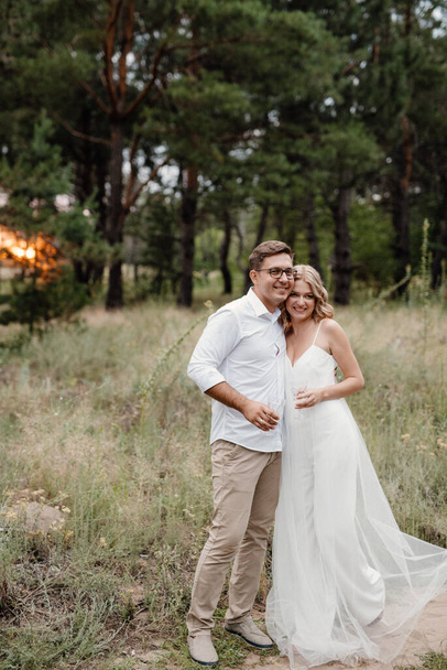 young couple of newlyweds on a walk in a pine forest - Foto, Bild