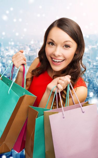 smiling woman with colorful shopping bags - Foto, Imagen