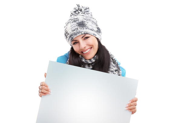 Menina sorridente apontando para uma placa em branco
 - Foto, Imagem