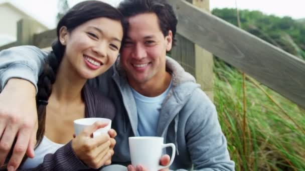 Couple on beach drinking coffee - Footage, Video