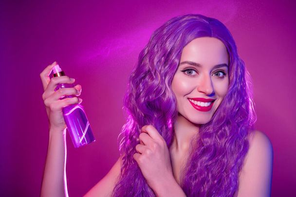 Close up studio photo of funny pretty theme party anime lady with wavy elven hair fixing hairdo over lilac background. - Foto, Imagem