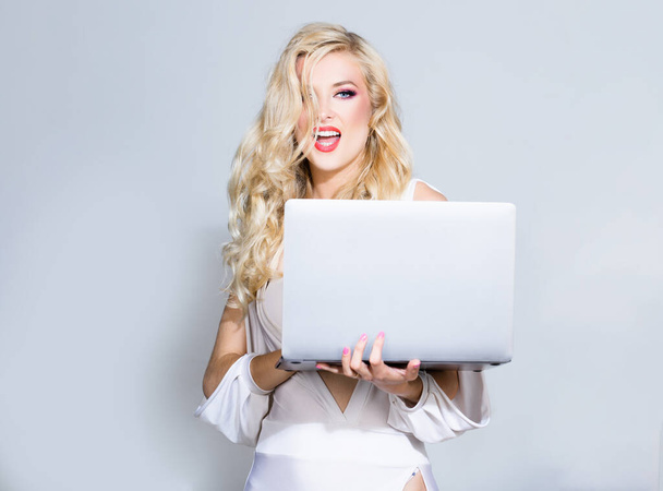Sexy secretary. Beauty blonde woman using laptop computer isolated background - Foto, Imagen