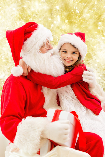 smiling little girl with santa claus - Fotó, kép