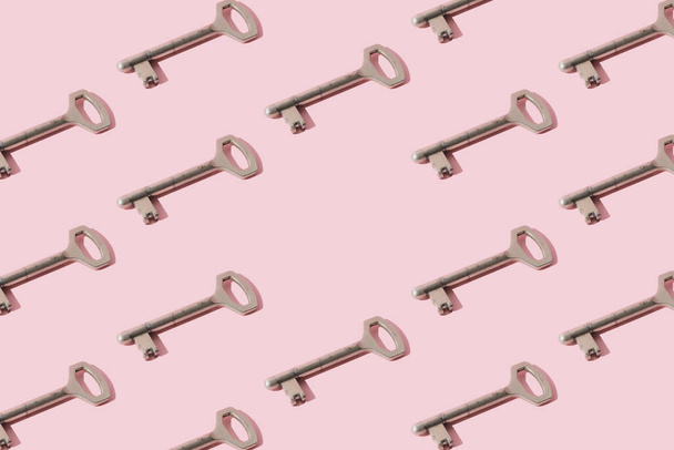 Metal key on a pink background. Pattern. Copy space. - Fotó, kép
