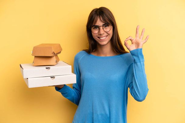 pretty woman feeling happy, showing approval with okay gesture. take away fast food concept - Zdjęcie, obraz