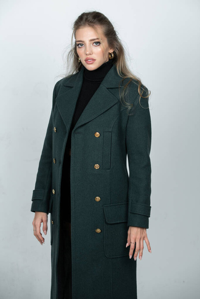 Vogue female coat. Young glamour woman wearing stylish fashion dress. Fashion model in studio - Foto, Bild