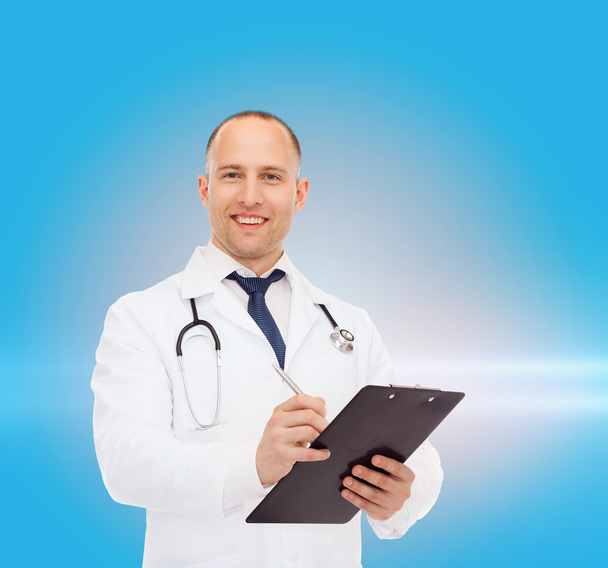 smiling male doctor with clipboard and stethoscope - 写真・画像