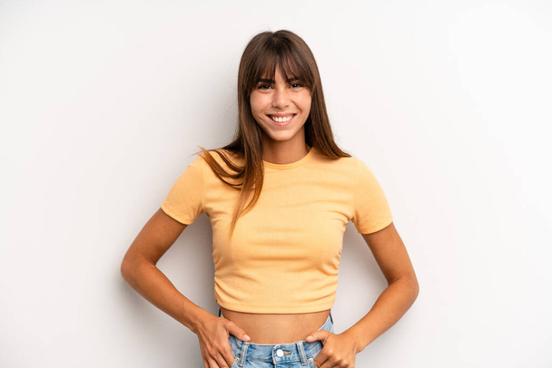 hispanic pretty woman smiling cheerfully and casually with a positive, happy, confident and relaxed expression - Photo, image