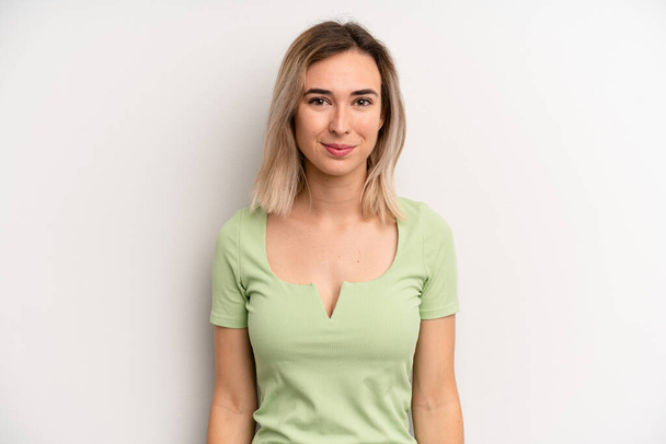 young adult blonde woman smiling positively and confidently, looking satisfied, friendly and happy - Fotó, kép