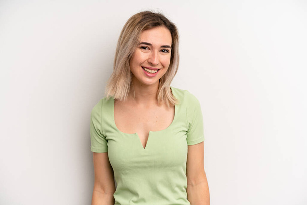 young adult blonde woman with a big, friendly, carefree smile, looking positive, relaxed and happy, chilling - Valokuva, kuva