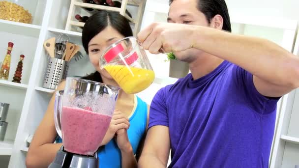 Couple adding freshly squeezed orange juice - Footage, Video
